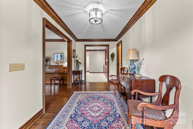 foyer with crown molding, baseboards, and wood finished floors