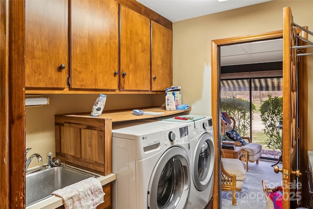 laundry room featuring carpet flooring, a sink, cabinet space, and washer and dryer