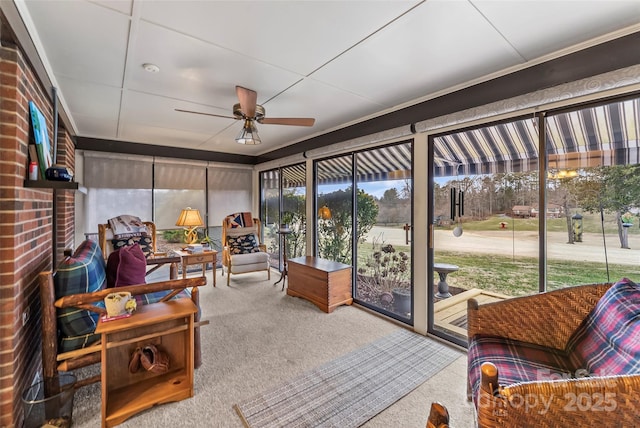 sunroom featuring a ceiling fan