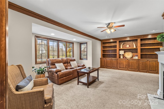 living room with ceiling fan, ornamental molding, carpet, and recessed lighting