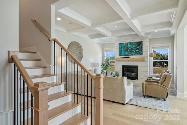 staircase featuring a fireplace, recessed lighting, wood finished floors, beamed ceiling, and coffered ceiling