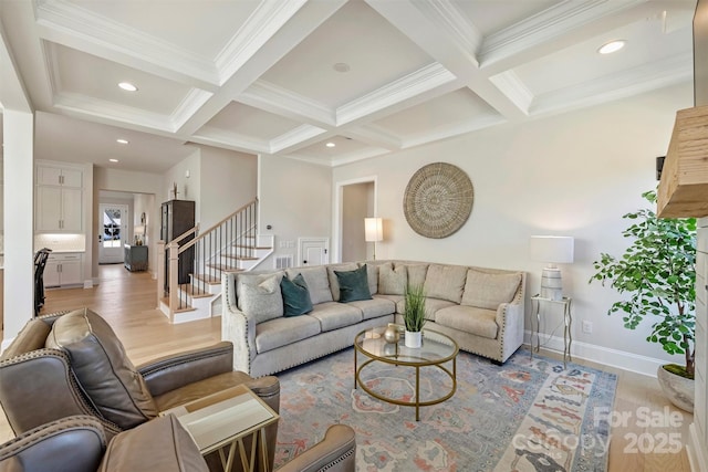 living room with stairs, beamed ceiling, and coffered ceiling