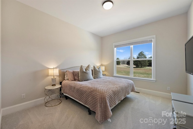 bedroom featuring baseboards and carpet flooring