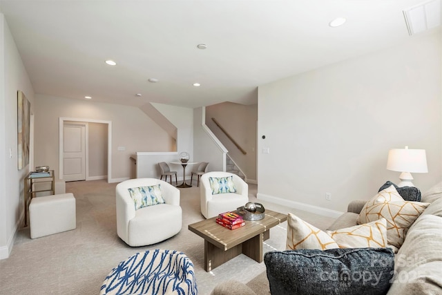 carpeted living area featuring recessed lighting, baseboards, and stairway