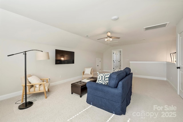 living area with light colored carpet, ceiling fan, visible vents, and baseboards