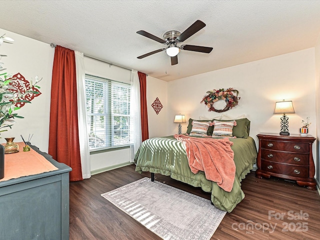 bedroom with a ceiling fan, wood finished floors, and a textured ceiling