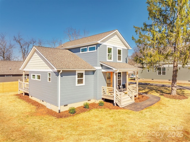 exterior space with crawl space, a porch, a shingled roof, and a front yard