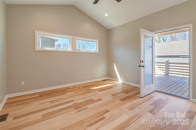 empty room featuring visible vents, ceiling fan, baseboards, lofted ceiling, and light wood-style floors