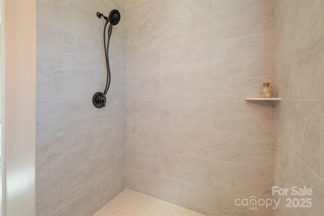 full bath with a tile shower