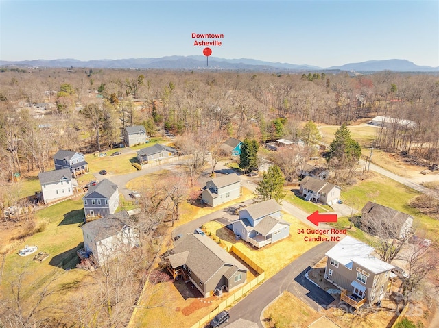 aerial view with a residential view, a mountain view, and a wooded view