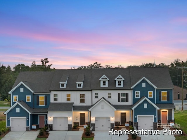 townhome / multi-family property featuring a garage, concrete driveway, and a shingled roof