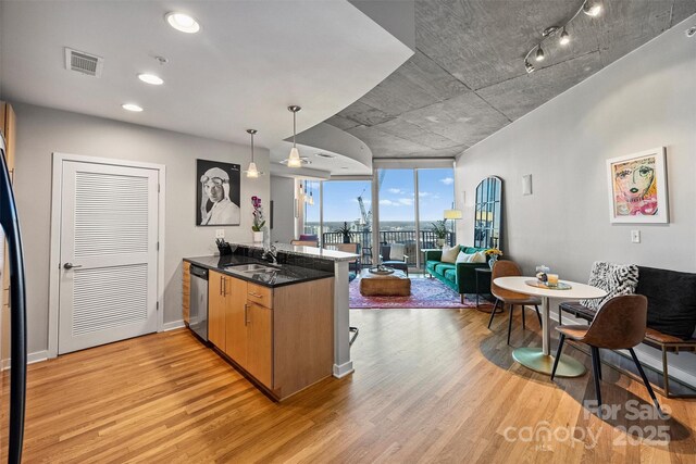 210 N Church St Unit 1413, Charlotte, NC 28202 - kitchen featuring a peninsula, light wood-style flooring, open floor plan, visible vents, and dishwasher