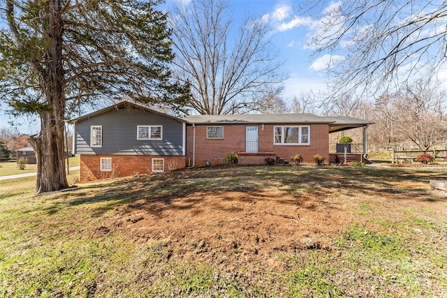 view of front of home with covered porch, a front yard, and brick siding