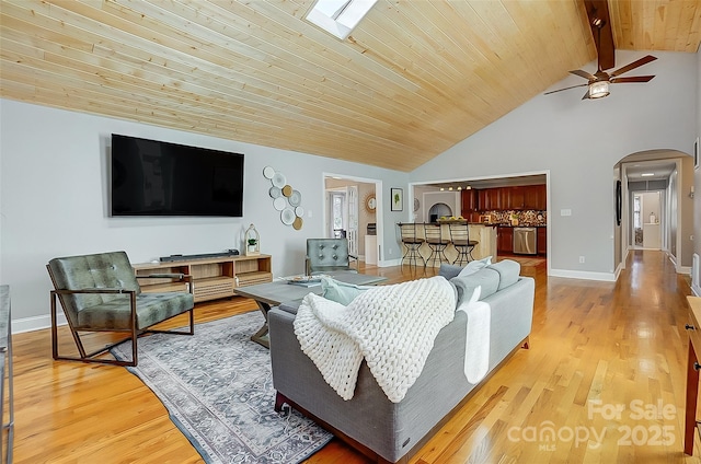 living room with arched walkways, light wood finished floors, wood ceiling, ceiling fan, and baseboards