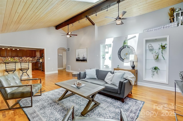 living room with wooden ceiling, light wood-style flooring, arched walkways, and a ceiling fan