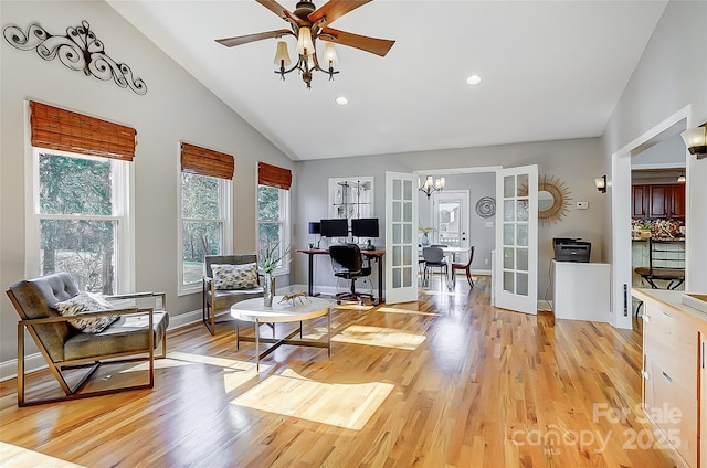 interior space with baseboards, french doors, light wood-style flooring, and a ceiling fan