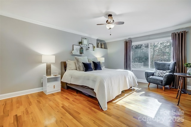 bedroom featuring ceiling fan, ornamental molding, light wood-style flooring, and baseboards