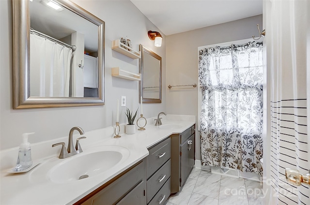 bathroom featuring marble finish floor, double vanity, a shower with shower curtain, and a sink