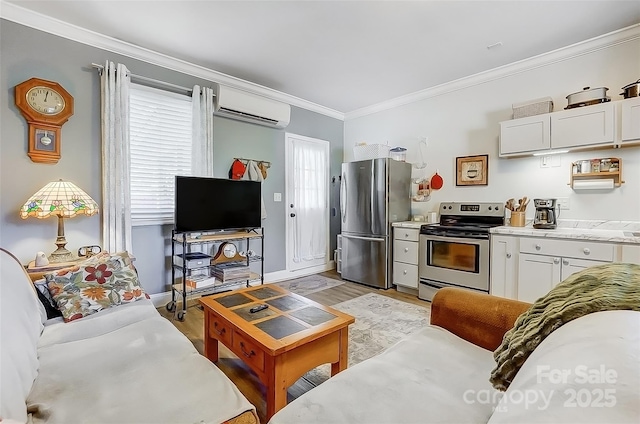 living area with light wood finished floors, ornamental molding, a wall mounted AC, and baseboards