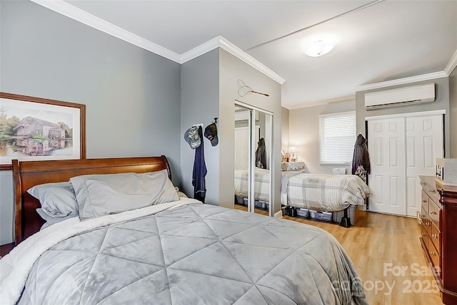 bedroom with ornamental molding, a closet, a wall mounted air conditioner, and light wood-style floors