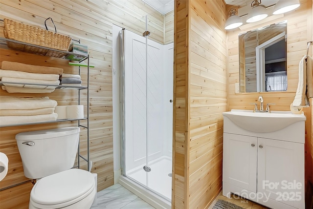 bathroom featuring marble finish floor, wood walls, toilet, and a stall shower