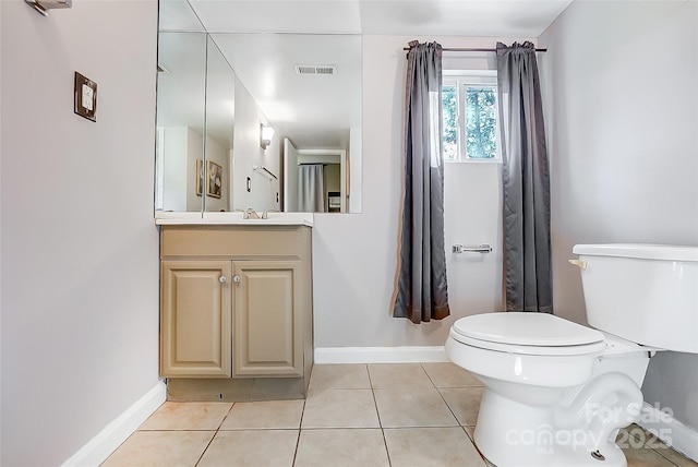 bathroom with visible vents, toilet, vanity, tile patterned flooring, and baseboards