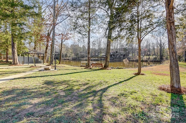 view of yard with a gazebo and a water view