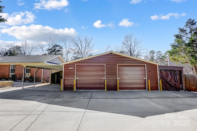 detached garage featuring fence