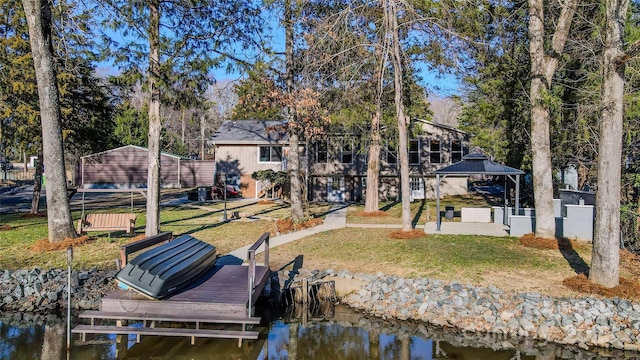 view of dock with a water view, a yard, and a gazebo