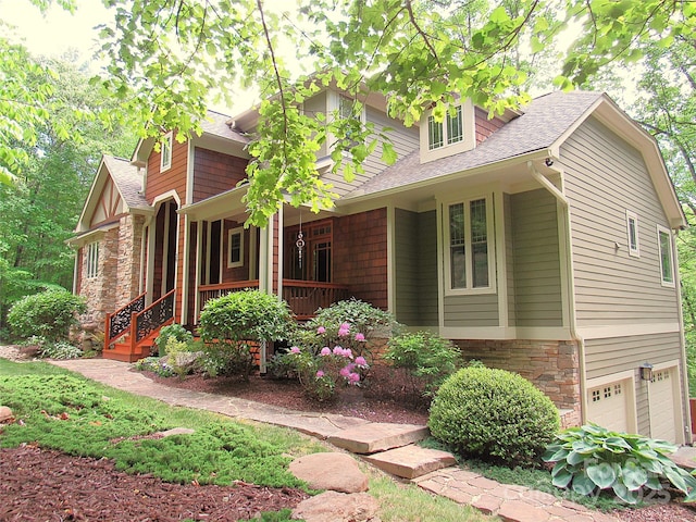 39 Hawks Pointe Ln, Weaverville, NC 28787 - view of front of house featuring a porch, a shingled roof, stone siding, and a garage