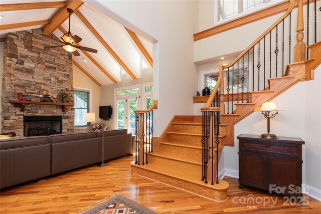 39 Hawks Pointe Ln, Weaverville, NC 28787 - living room featuring high vaulted ceiling, wood finished floors, beam ceiling, ceiling fan, and a stone fireplace