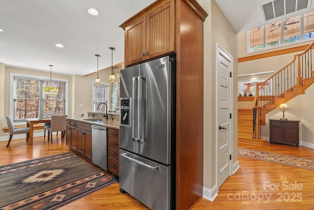 39 Hawks Pointe Ln, Weaverville, NC 28787 - kitchen with stainless steel appliances, a sink, light wood finished floors, baseboards, and light stone counters
