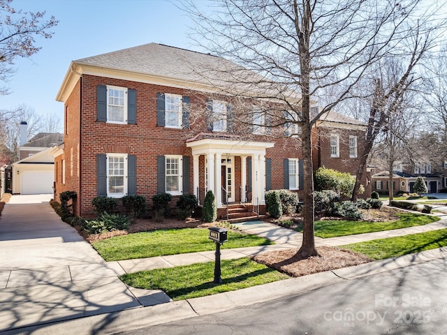 colonial house with a garage and brick siding