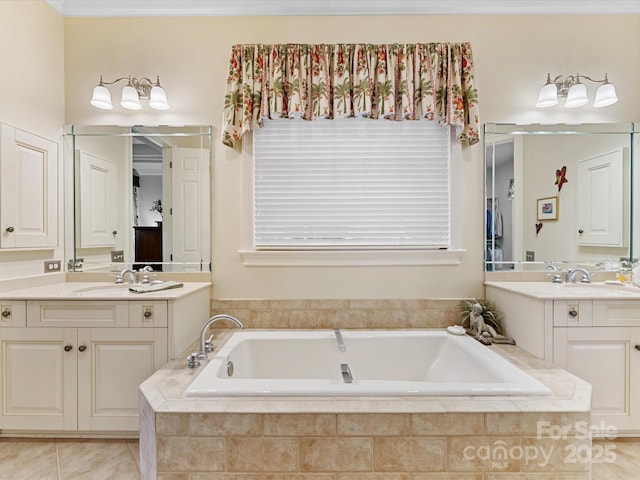 bathroom with two vanities, a garden tub, a sink, and tile patterned floors