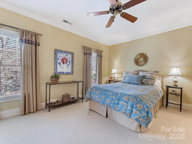 bedroom featuring visible vents, crown molding, and multiple windows