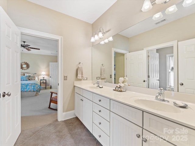 ensuite bathroom featuring connected bathroom, tile patterned flooring, visible vents, and a sink