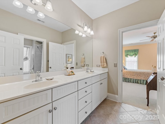 ensuite bathroom with tile patterned flooring, visible vents, a sink, and ensuite bathroom