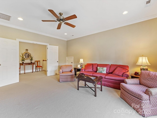 living area with recessed lighting, visible vents, light colored carpet, and ornamental molding