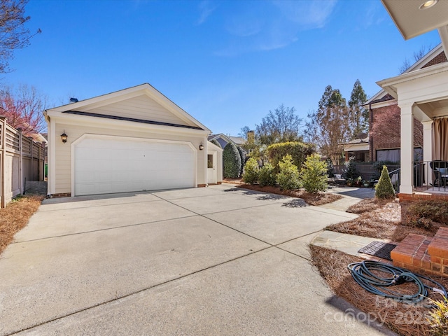 view of side of home with driveway and an outdoor structure