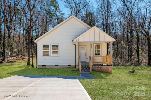 bungalow-style house with board and batten siding, a front yard, crawl space, and covered porch