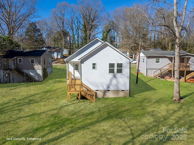 back of property with a residential view, crawl space, a yard, and stairway