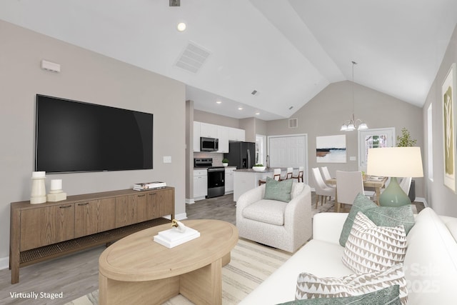 living room with light wood-style flooring, visible vents, a notable chandelier, and recessed lighting