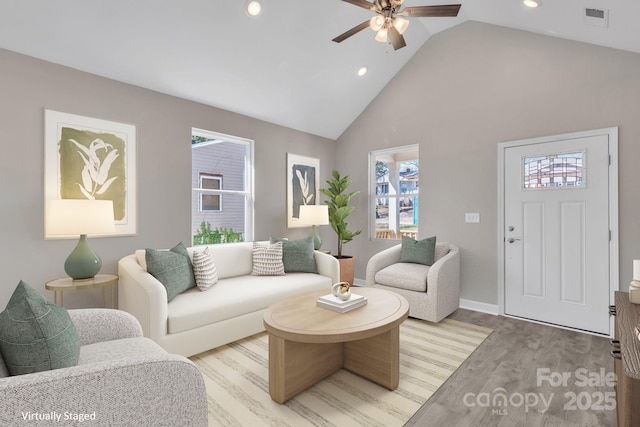 living room featuring ceiling fan, high vaulted ceiling, recessed lighting, visible vents, and light wood-type flooring