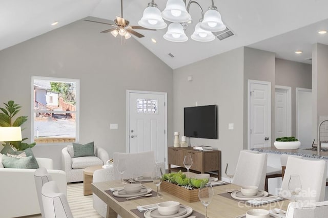 living area featuring a ceiling fan, plenty of natural light, and high vaulted ceiling