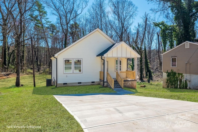 view of front facade with central air condition unit, covered porch, board and batten siding, a front yard, and crawl space