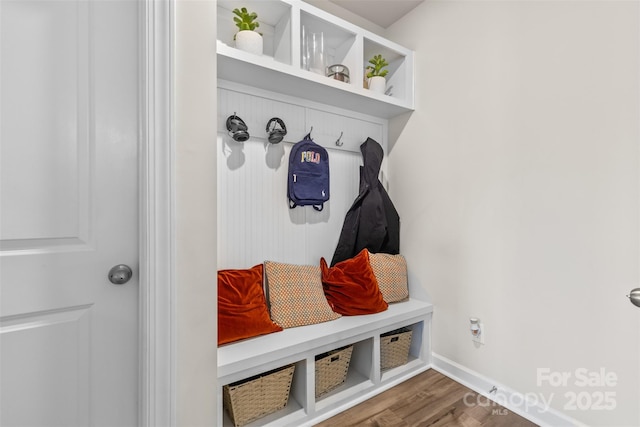 mudroom featuring baseboards and dark wood-style flooring