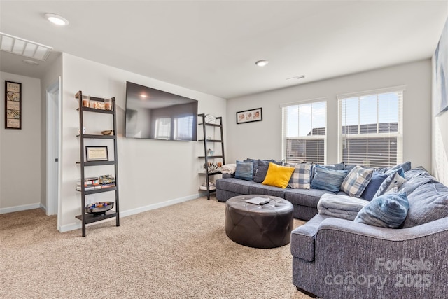 carpeted living area featuring recessed lighting and baseboards