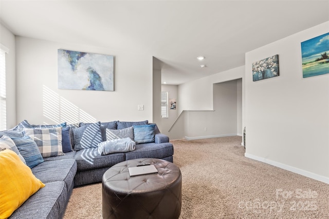 carpeted living room featuring baseboards