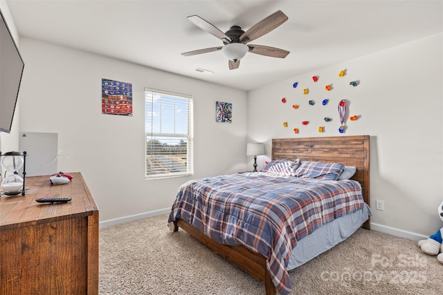 carpeted bedroom featuring a ceiling fan, visible vents, and baseboards