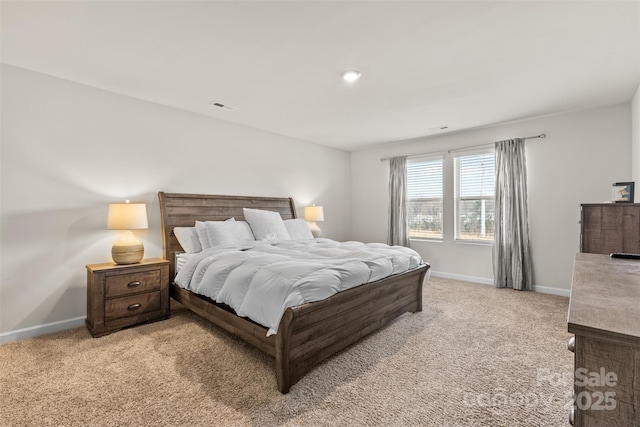 bedroom featuring visible vents, light carpet, and baseboards